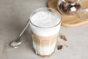Delicious latte macchiato in glass on grey table
