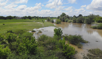 Flooded field with farm after heavy rains storm