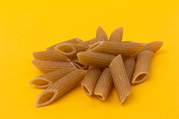 Pasta from hard wheat. Italian pasta on yellow background,  place for text.