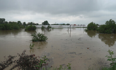 Water flowing on farm field waterway after heavy rain and storms caused flooding.