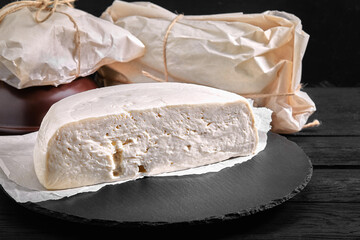 Traditional Caucasian homemade cheese sulguni on stone board, selective focus