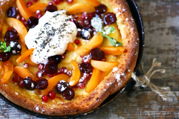 Dutch baby pancake with fruits and berries. Healthy breakfast. Food Trend Dessert.