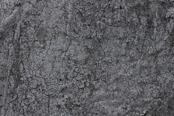 Dark grey aged paint background with cracks. Black brick stone texture used for wallpapers, your text sign. Cement blocks backdrop for advertising design mockup. Architecture details.