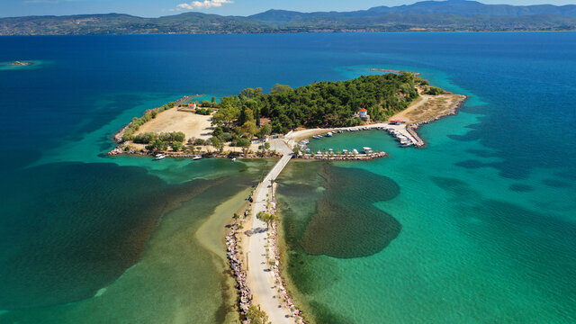 Aerial drone photo of famous island of dreams or Pesonisi connecting with small road with seaside fishing village of Eretria, Central Evia island, Greece