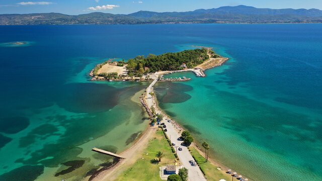 Aerial drone photo of famous island of dreams or Pesonisi connecting with small road with seaside fishing village of Eretria, Central Evia island, Greece