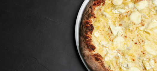 Top view of hot delicious pizza on dark table, space for text. Banner design