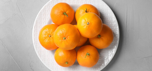 Fresh ripe tangerines on light table, top view. Banner design