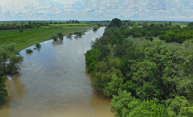 Fototapeta premium Water flowing in farm field waterway on field flooded damage after heavy rain