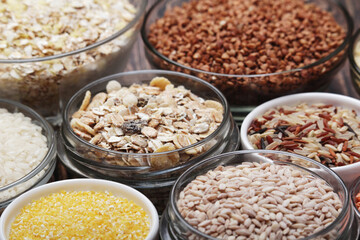 A set of bowls filled with different seeds: buckwheat, rise, corn and oatmeal
