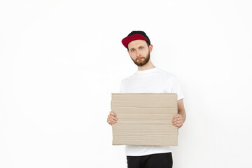 Young man protesting with blank board, sign isolated on white studio background. Activism, active social position, protest, actual problems. Meeting against human rights, abusing, freedom of choice.