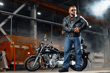 Fototapeta na wymiar Portrait of motorbike rider in black leather outfit
