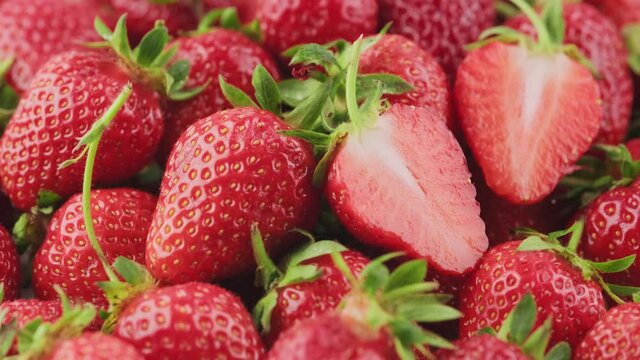 Ripe strawberries rotate macro shooting, seasonal red berry, homemade strawberries