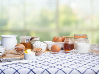 Selective focus.Cooking breakfast food or bakery with ingredient and copy space of tablecloth on blur green bokeh