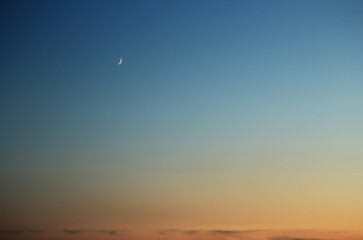 New moon on sunset in the sky