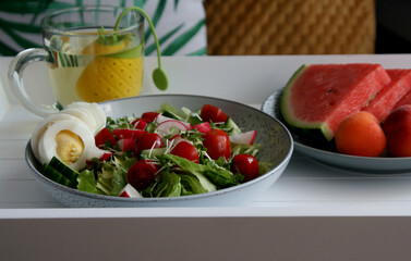 healthy, vegeterian, organic salad with egg, raddish and tomatoes. watermelon