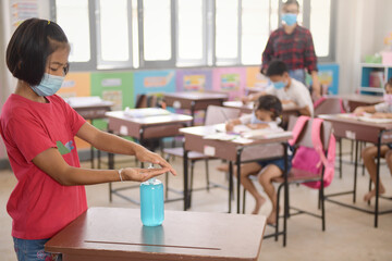 Washing Hand By Sanitizer Gel For Prevention Coronavirus Disease (Covid-19) in classroom.Washing hands by alcohol sanitizers or alcohol gel from pump bottle in public area.
