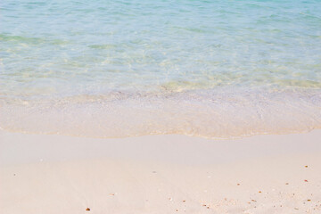 Fototapeta na wymiar Sandy beach and blue sea in summer