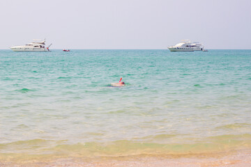 Tourists are diving on the beach on summer