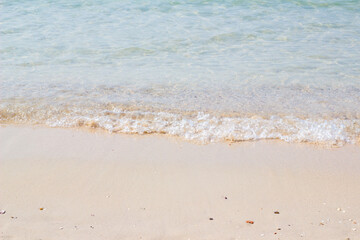 Fototapeta na wymiar Sandy beach and blue sea in summer soft focus