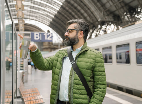 Man checking the timetable at the train station
