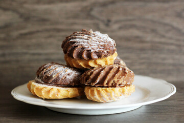 Delicious fresh cookies, light and dark, wooden background