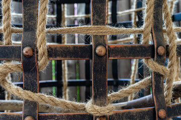 The iron cage is decorated with a rope