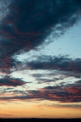 the sky at sunset is orange and red with clouds, the sky is dramatic colors