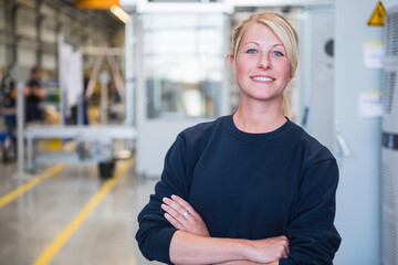 Portrait of confident young woman in a factory