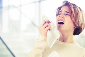 Allergies or cold concept. Young woman blowing nose