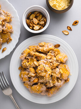 Plate of homemade gnocchi with pumpkin seeds