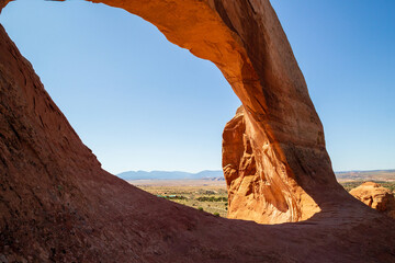 Wilson Arch, a natural sandstone arch located 24 miles south of Moab, Utah. Amazing view looking down into the valley