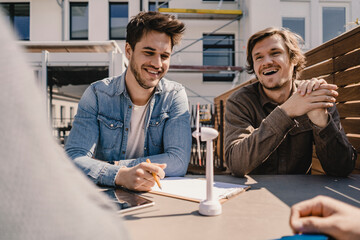 Young entrepreneurs brainstorming on a roof terrace