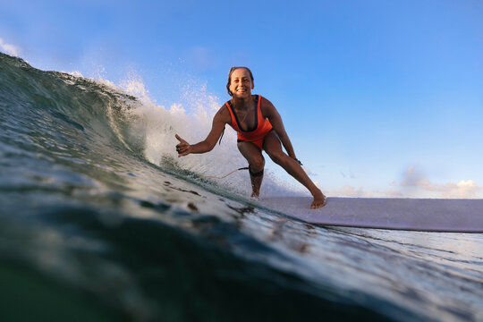 Female surfer with thumb up