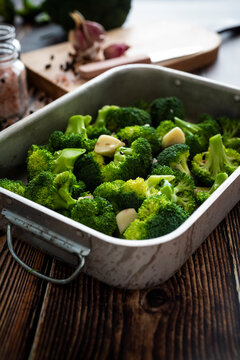 Baking pan with chopped broccoli and garlic