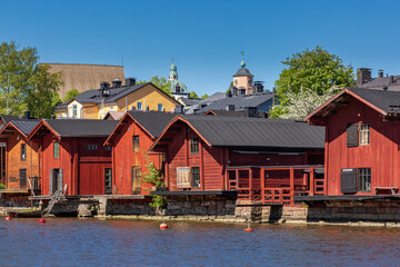 Fototapeta premium Old red wooden buildings on the river in Porvoo, Finland