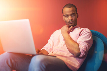 Thoughtful handsome professional IT programmer thinking about new features for implementation in personal startup project and surfing information on internet via modern laptop computer connected to 4G