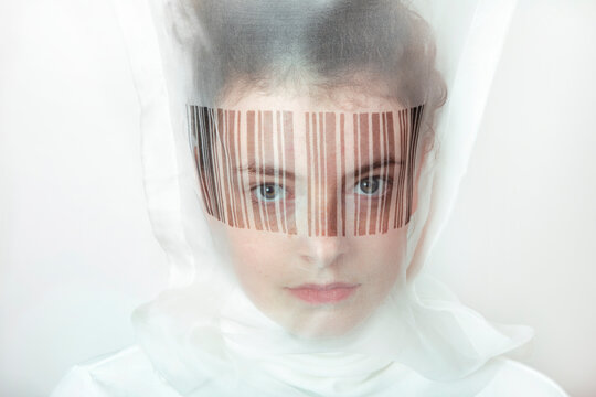 Portrait of young woman wearing  transparent mask with bar code
