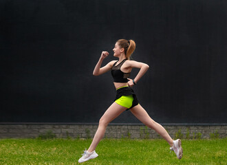 athlete runs and does cardio-fitness training. Active healthy lifestyle in the summer outdoors in...