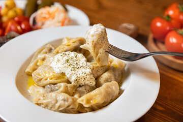 Tasty xingal meat meal with yogurt, Taking with fork