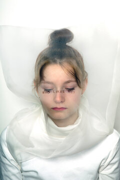 Portrait of sad teenage girl wearing  transparent mask with question