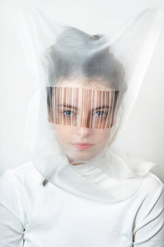 Portrait of young woman wearing  transparent mask with bar code