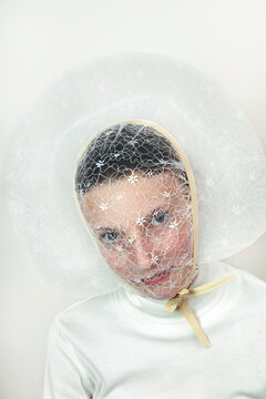 Portrait of teenage girl wearing bonnet white veil