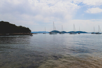 Fototapeta premium Vrgada island shallow bay, popular tourist spot because of landslide created beaches, full of yachts during tourist season