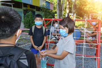 Washing Hand By Sanitizer Gel For Prevention Coronavirus Disease (Covid-19) in Playground. Washing hands by alcohol sanitizers or alcohol gel from pump bottle in public area.