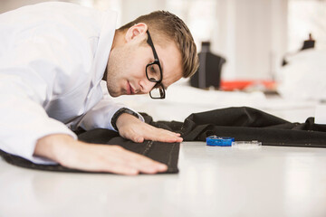 Fashion designer examining fabric