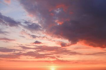 Beautiful bright colorful  pink red yellow clouds on dark sky at sunset or sunrise. Evening or morning sky natural eco background. Amazing nature texture surface wallpaper.