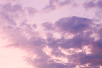Fototapeta premium Beautiful bright colorful pink red yellow clouds on dark sky at sunset or sunrise. Evening or morning sky natural eco background. Amazing nature texture surface wallpaper.