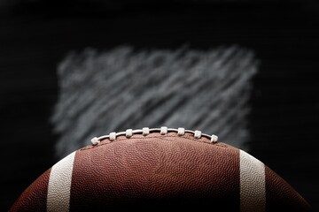 American leather football ball on dark background