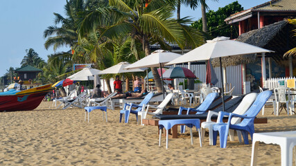 People relaxing on a public cabana in the beach
