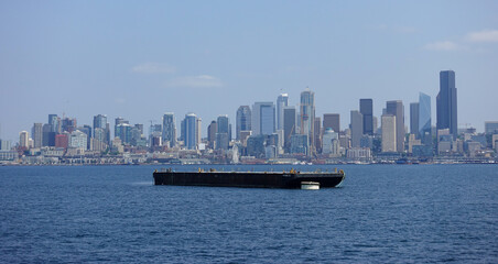 Fototapeta na wymiar Large barge near the skyline of Seattle, Washington